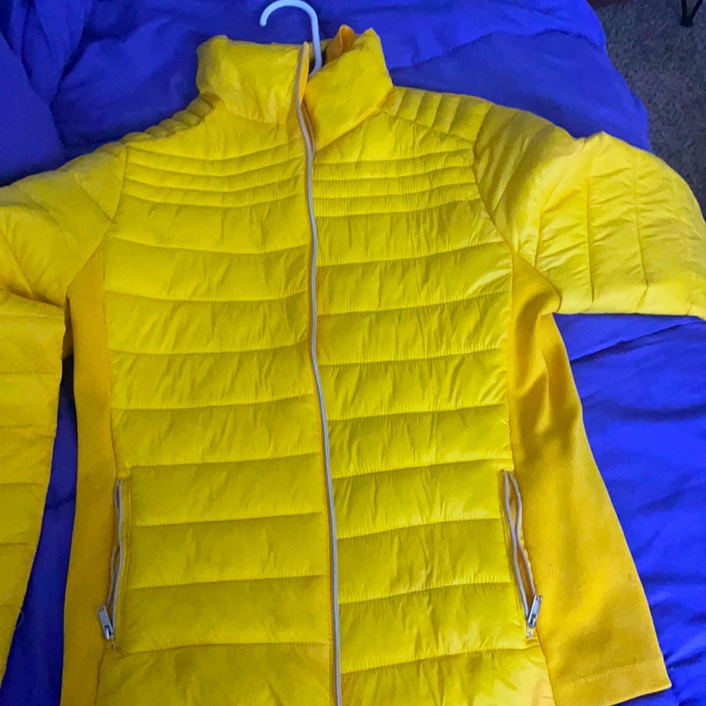 A woman’s small yellow light weight jacket